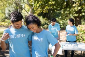 Smiling volunteers talking to each other